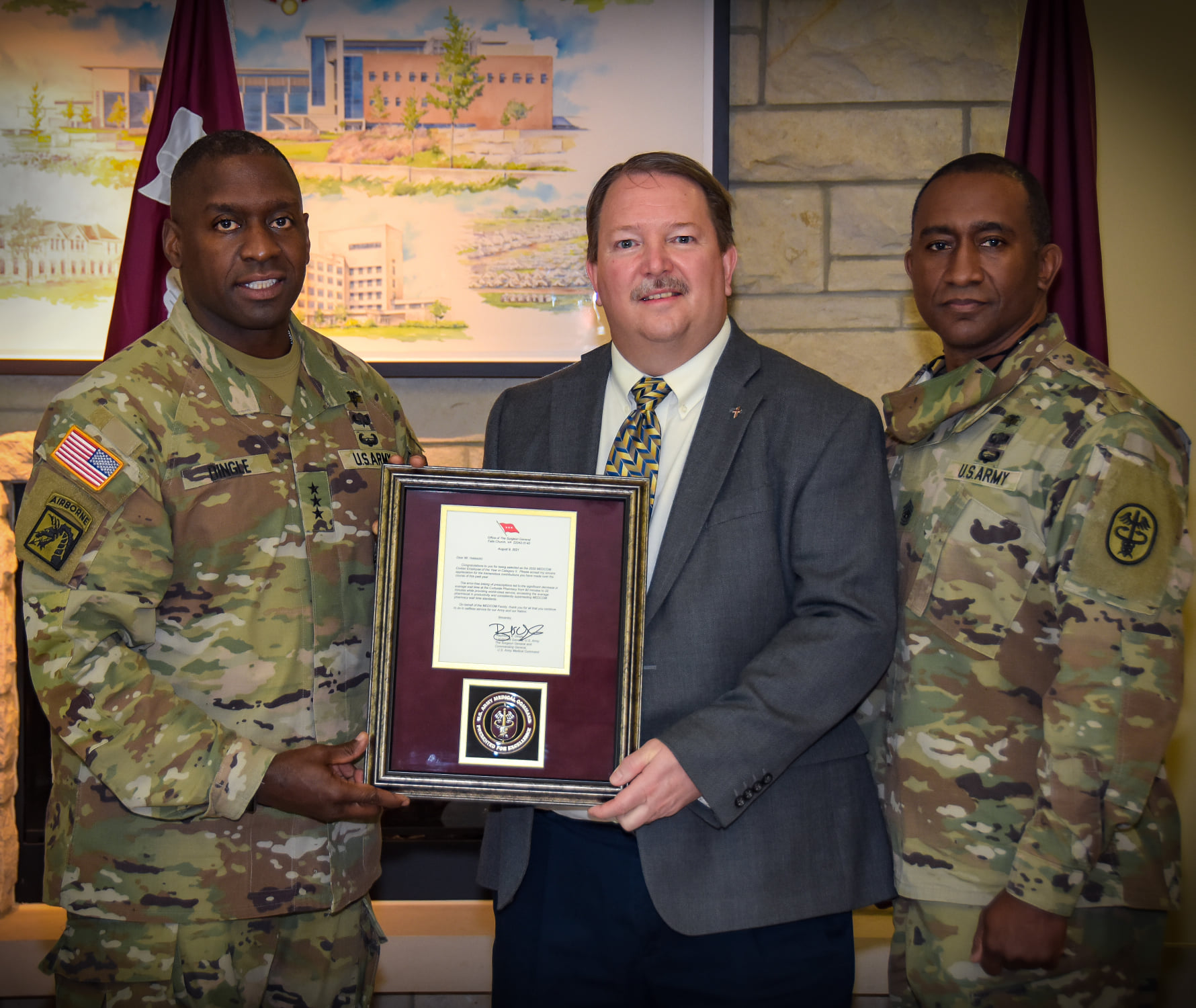 David Hatesohl (center), is awarded the MEDCOM Civilian of the Year Award by 45th Surgeon General of the U.S. Army and Commanding General for the U.S. Army Medical Command Lt. Gen. Raymond Dingle (left) and Sgt. Maj. Diamond Hough (right).